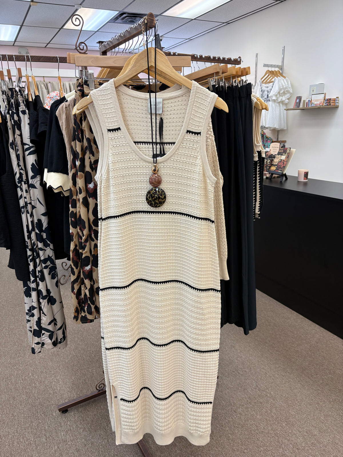 Varley scoop neck dress displayed on a model, featuring a sleek, fitted design with a soft fabric and stylish neckline.