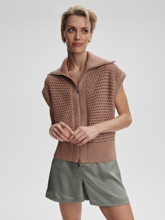 Varley Liliana knit gilet displayed on a model, featuring a cozy, textured knit design in neutral tones.