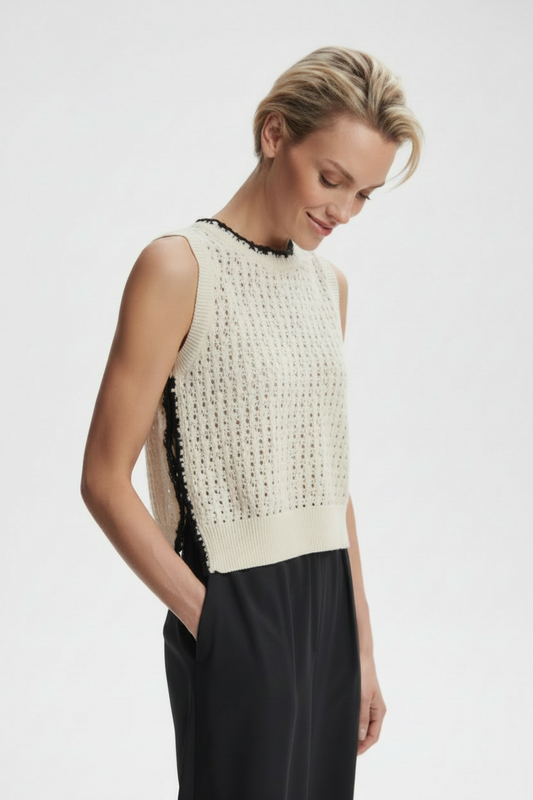 Varley Delaney knit vest in a cozy, textured fabric, displayed on a hanger with a neutral background.